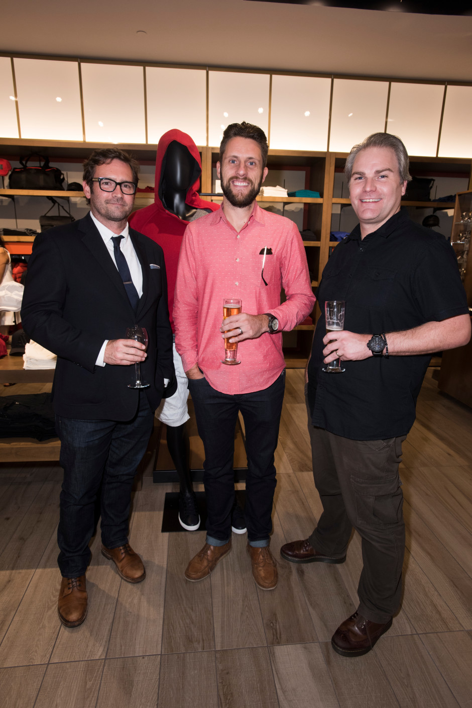 Steve Evans, Zach Brown and Marty Christiansen pose for a photo at the Armani Exchange in Dallas, Texas on September 24, 2015.