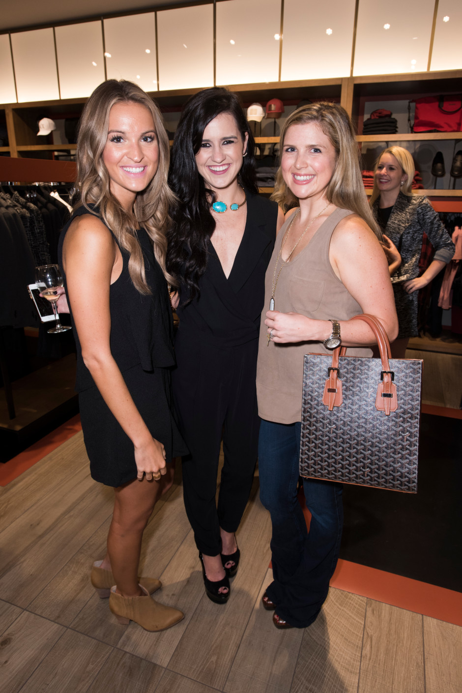 Lauren Sims, Ellen Flowers and Chandler Hatchett pose for a photo at the Armani Exchange in Dallas, Texas on September 24, 2015.