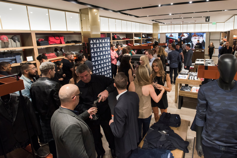 Guests enjoy the opening of the new Armani Exchange in Dallas, Texas on September 24, 2015.