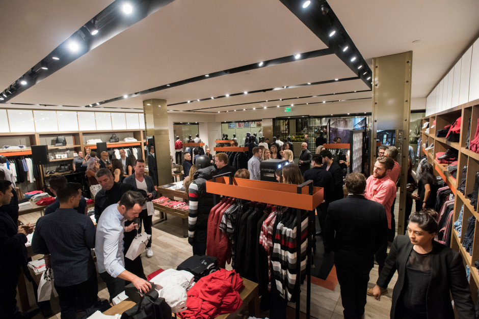Guests enjoy the opening of the new Armani Exchange in Dallas, Texas on September 24, 2015.