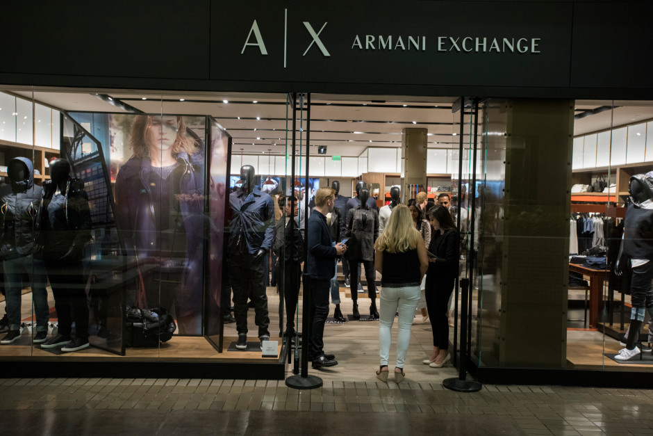 Guests enjoy the opening of the new Armani Exchange in Dallas, Texas on September 24, 2015.