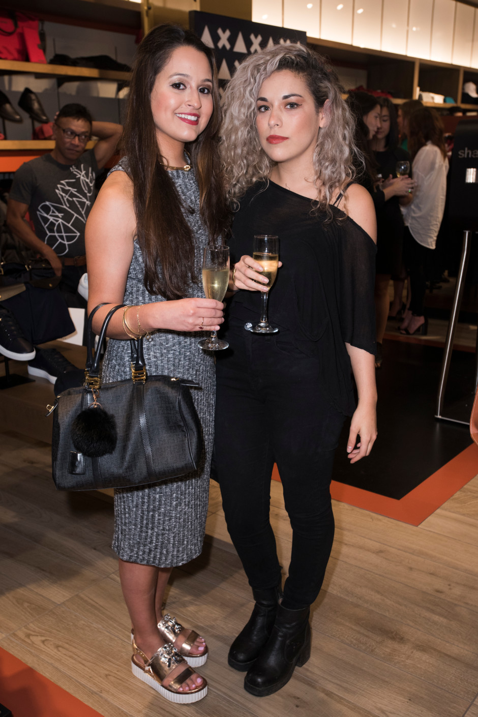 Carla Toledo and Evelia Chapa pose for a photo at the Armani Exchange in Dallas, Texas on September 24, 2015.