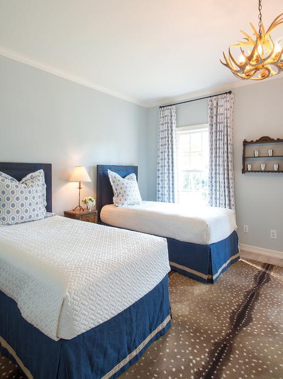 blue-twin-bedroom-antelope-rug-faux-antler-chandelier